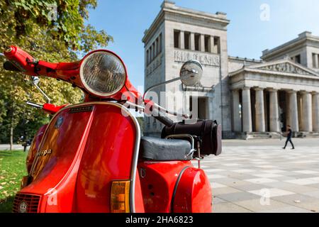 red vespa scooter in front of the propylaea in munich on koenigsplatz Stock Photo