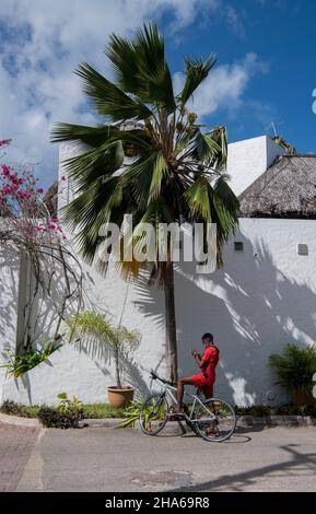 Boy on bike Cote D'Or Beach Praslin Seychelles Stock Photo