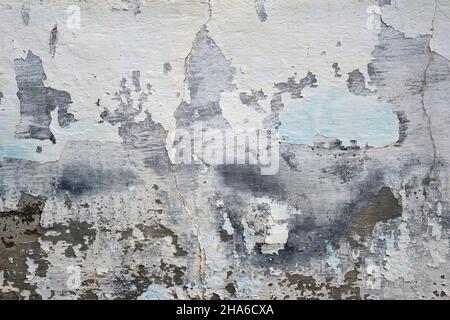 Old weathered wall with damp peeled lime wash plaster finish Stock Photo