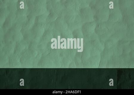 Green painted concrete wall with darker skirting board Stock Photo