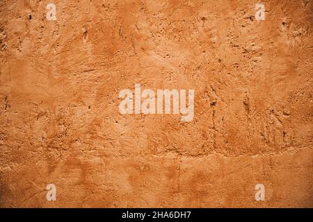 Terracotta colored plaster wall, rustic background or texture Stock Photo