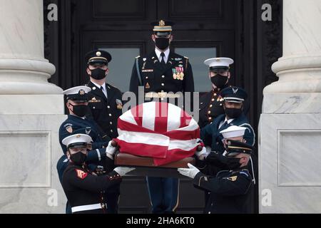 Washington, DC. 10th Dec, 2021. WASHINGTON, DC - DECEMBER 10: A joint services military honor guard carries the casket of the late Sen. Robert Dole (R-KS) down the steps of the U.S. Capitol after lying in state on December 10, 2021 in Washington, DC. Dole, a veteran who was severely injured in World War II, was a Republican Senator from Kansas from 1969 to 1996. He ran for president three times and became the Republican nominee for president in 1996. Credit: Anna Moneymaker/Pool via CNP/dpa/Alamy Live News Stock Photo
