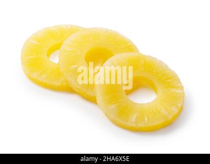 Pineapple slices placed on a white background. Contents of a can of pineapple. Stock Photo