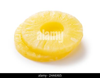 Pineapple slices placed on a white background. Contents of a can of pineapple. Stock Photo