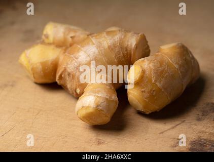 Ginger placed against the old wooden background. Shallow depth of field. Stock Photo
