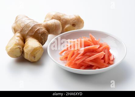 Red ginger placed on a white background. Red pickled ginger in Japan Stock Photo