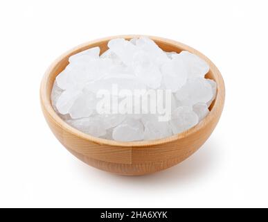 rock candy in a wooden bowl set against a white background. Stock Photo