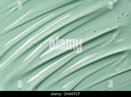 Serum texture on transparent liquid gel background with green background.  Transparent beauty skin care product sample. Stock Photo