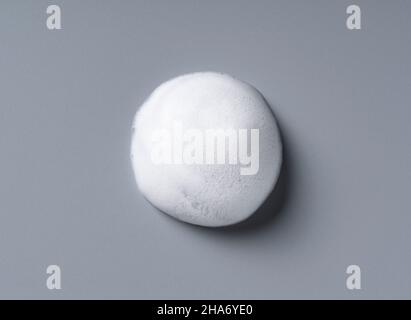 Foam texture on gray background. Soap, shampoo, mousse, shower gel foam. Stock Photo