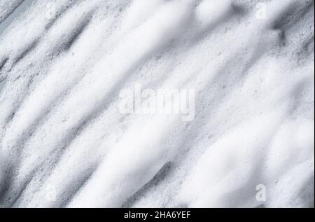 Bubbles texture background on gray background. Soap, shampoo, mousse, shower gel foam. Stock Photo