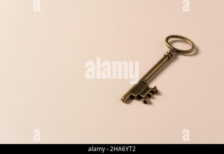 Retro brass keys on a beige background with copy space. Stock Photo