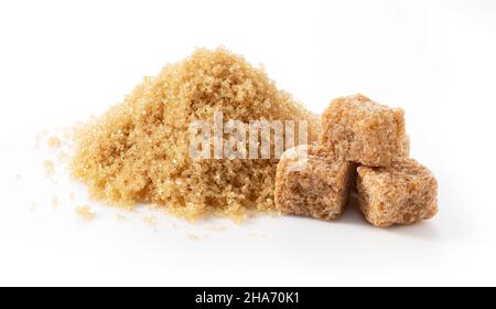 Brown cane sugar powder and brown sugar cubes placed on a white background. Stock Photo