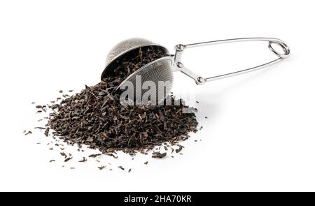 Earl Grey tea leaves and stainless steel tea strainer on white background Stock Photo