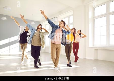 Group of happy young people having a contemporary dance class in a modern studio Stock Photo