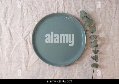 Green colored circle shaped ceramic plate on isolated background, food mockup Stock Photo