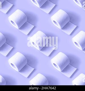 White toilet paper roll repeat seamless pattern on light blue Very Peri background. Stock Photo