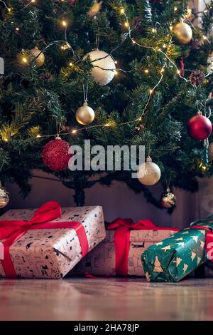 Presents set on the floor under the christmas tree on a beautiful holiday at home. Christmas, home, presents Stock Photo