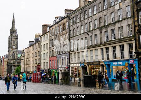 Edinburgh, Scotland, 12 June 2019: Tourists and old buildings on the historic Royal Mile street and area, in a cloudy summer day Stock Photo