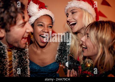 Happy group of friends celebrate New Year's Eve while dancing Stock Photo