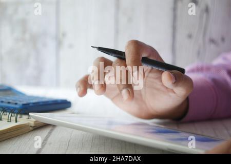 analyzing stock market data on digital tablet  Stock Photo