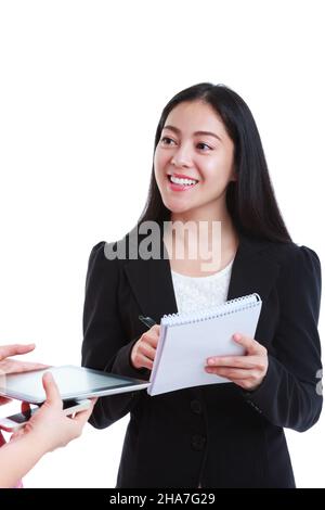 Businesswoman talking with someone holding using digital tablet. Asian woman tooth smile, she has a look of enjoyment on her face, on white background Stock Photo