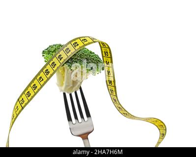 fresh healthy broccoli floret on fork with yellow tape measure isolated on white background Stock Photo