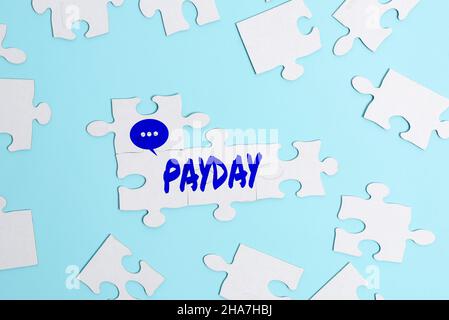 Hand writing sign Payday. Business overview a day on which someone is paid or expects to be paid their wages Building An Unfinished White Jigsaw Stock Photo