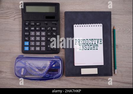 Text sign showing Predictive Insight. Business showcase Proactive Fault Management System an Early Detection Blank Notebook Page With A Calculator And Stock Photo