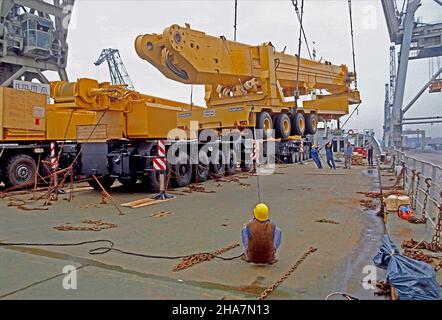 Heavy cargo, a mobile crane, being loaded onto the upper deck of a ro-ro vessel in the port of Hamburg, Germany. Stock Photo