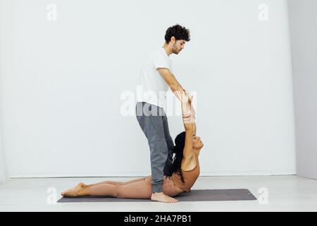 man and woman together doing exercises yoga asana fitness Stock Photo
