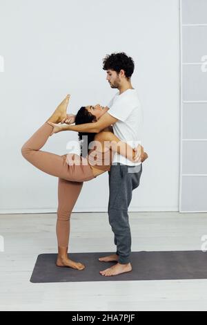 Man and woman together doing exercises family yoga asana fitness Stock Photo