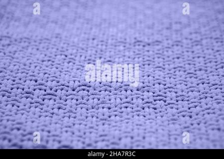Color of the year 2022 very peri. Knitted sweater texture closeup. Trendy soft abstract background. Stock Photo