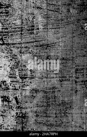 Old faded painted black wall. Weathered peeling surface. Abstract dark background. Vertical view Stock Photo