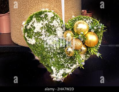 Detail of ornate heart shaped Christmas decoration with gold bulbs ornaments Stock Photo