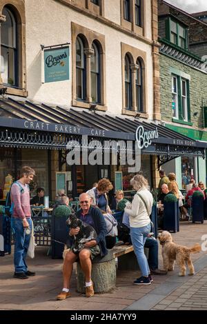 UK, Cumbria, Allerdale, Keswick, Main Street, customers in sunshine outside Bryson’s café & Tea Room in pedestrianised shopping street Stock Photo