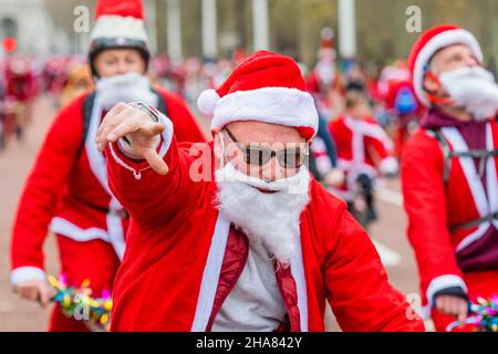 London, UK. 11th Dec, 2021. Riding down the Mall in Sant suits - The BMX Life Santa Cruise bike ride in support of the ECHO (Evelina Childrens Heart Organisation) children's heart charity. Credit: Guy Bell/Alamy Live News Stock Photo