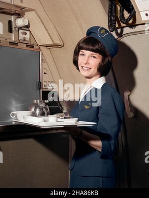 1960s SMILING WOMAN FLIGHT ATTENDANT HOLDING TRAY WITH COFFEE SERVICE ITEMS LOOKING AT CAMERA - a7294c HAR001 HARS CAREER CREW PLEASED JOY LIFESTYLE PLANES AIRLINE FEMALES JOBS FLIGHT PORTRAITS COPY SPACE HALF-LENGTH LADIES PERSONS PROFESSION EXPRESSIONS BRUNETTE SKILL OCCUPATION SKILLS CHEERFUL ADVENTURE BEVERAGE ITEMS CUSTOMER SERVICE CAREERS WORKPLACE LABOR AVIATION EMPLOYMENT OCCUPATIONS SMILES JOYFUL STYLISH EMPLOYEE ATTENDANT COMMERCIAL AVIATION MID-ADULT MID-ADULT WOMAN STEWARDESS CABIN CREW CAUCASIAN ETHNICITY HAR001 LABORING OLD FASHIONED Stock Photo