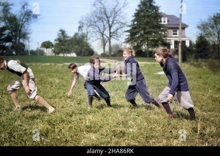 1920s 1930s GROUP OF EXUBERANT PRETEEN BOYS WEARING PLUS FOURS AND KNEE SOCKS PLAYING TOUCH FOOTBALL IN SUBURBAN GRASS FIELD - b1819c HAR001 HARS ROUGH CONFIDENCE ACTIVITY PASSING HAPPINESS PHYSICAL LEISURE STRENGTH STRATEGY AND EXCITEMENT EXTERIOR LEADERSHIP IN OF PRETEEN KNEE SOCKS CONCEPTUAL FLEXIBILITY MUSCLES STYLISH TUMBLE PLUS FOURS PRE-TEEN PRE-TEEN BOY TOGETHERNESS CAUCASIAN ETHNICITY EXUBERANT HAR001 OLD FASHIONED Stock Photo