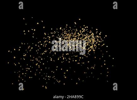 sparkling gold glitter dust sparks on black background Stock Photo