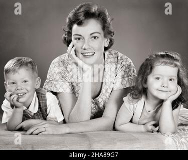 1950s Smiling Boy And Girl Brother And Older Sister Ladling Bread