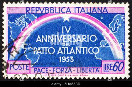 ITALY - CIRCA 1953: a stamp printed in the Italy shows Continents Joined by Rainbow, 4th Anniversary of Signing of the North Atlantic Treaty, circa 19 Stock Photo