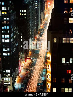 1970s NIGHT SCENE LOOKING UP 7TH AVENUE FROM MACY’S DEPARTMENT STORE TOWARD TIMES SQUARE NEW YORK CITY USA - kr14985 RSS001 HARS UNITED STATES COPY SPACE SCENIC UNITED STATES OF AMERICA AUTOMOBILE BUILDINGS TRANSPORTATION NORTH AMERICA NORTH AMERICAN MIDTOWN BRIGHT HIGH ANGLE ADVENTURE PROPERTY AUTOS EXCITEMENT TOWARD UP HEADLIGHTS NYC REAL ESTATE 7TH NEW YORK STRUCTURES AUTOMOBILES CITIES VEHICLES EDIFICE NEW YORK CITY MACY'S OLD FASHIONED Stock Photo