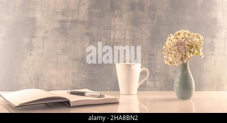 Book opened on a workspace. White pages for inscriptions. Stock Photo