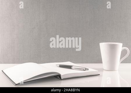 Book opened on a workspace. White pages for inscriptions. Stock Photo