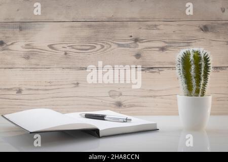 Book opened on a workspace. White pages for inscriptions. Stock Photo