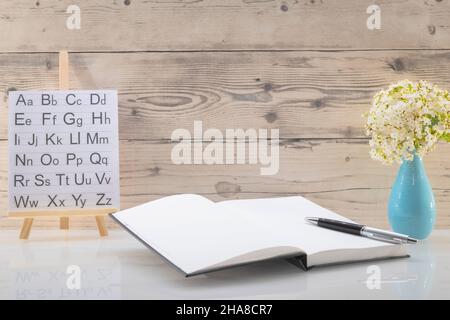 Book opened on a workspace. White pages for inscriptions. Stock Photo