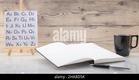Book opened on a workspace. White pages for inscriptions. Stock Photo