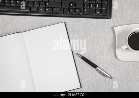 Book opened on a workspace. White pages for inscriptions. Stock Photo