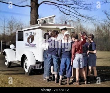 1940s GROUP OF BOYS CROWDING AROUND ICE CREAM MAN AT BACK OF GOOD HUMOR TRUCK - s10307c HAR001 HARS 1 PACKED WAGON JUVENILE MANY YOUNG ADULT SWEET SNACK JOY LIFESTYLE HISTORY CONE GROWNUP TREAT HORIZONTAL FRIENDSHIP FULL-LENGTH PERSONS MALES TEENAGE BOY SUNNY FOODS SNACK FOODS RELEASES PRETEEN BOY TRUCKS SNACKS NOURISH SNACK FOOD 1942 CONES OCCUPATIONS SMILES ICE CREAM CONE ICE CREAM CONES MANLY MEMBERS NOURISHMENT WAGONS ICE CREAM GOOD HUMOR DAYLIGHT ICE CREAM MAN ICE CREAM TRUCK ICE CREAM TRUCKS ICE CREAM WAGON ICE CREAM WAGONS JUNK FOOD MEMBER PRE-TEEN BOY YOUNG ADULT MAN YOUNGSTER Stock Photo