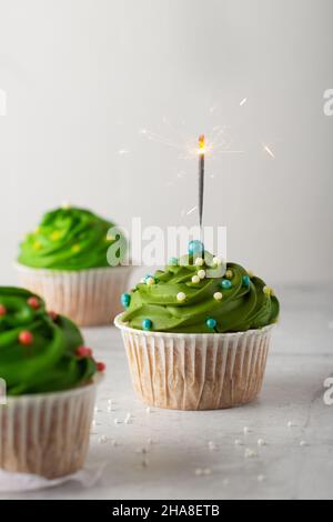 christmas cupcakes with green cream and sparklers Stock Photo